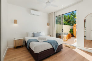 Master bedroom with direct access to the private sauna area at Poinciana Holiday House