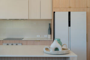 Modern kitchen with full-size fridge at Poinciana Holiday House