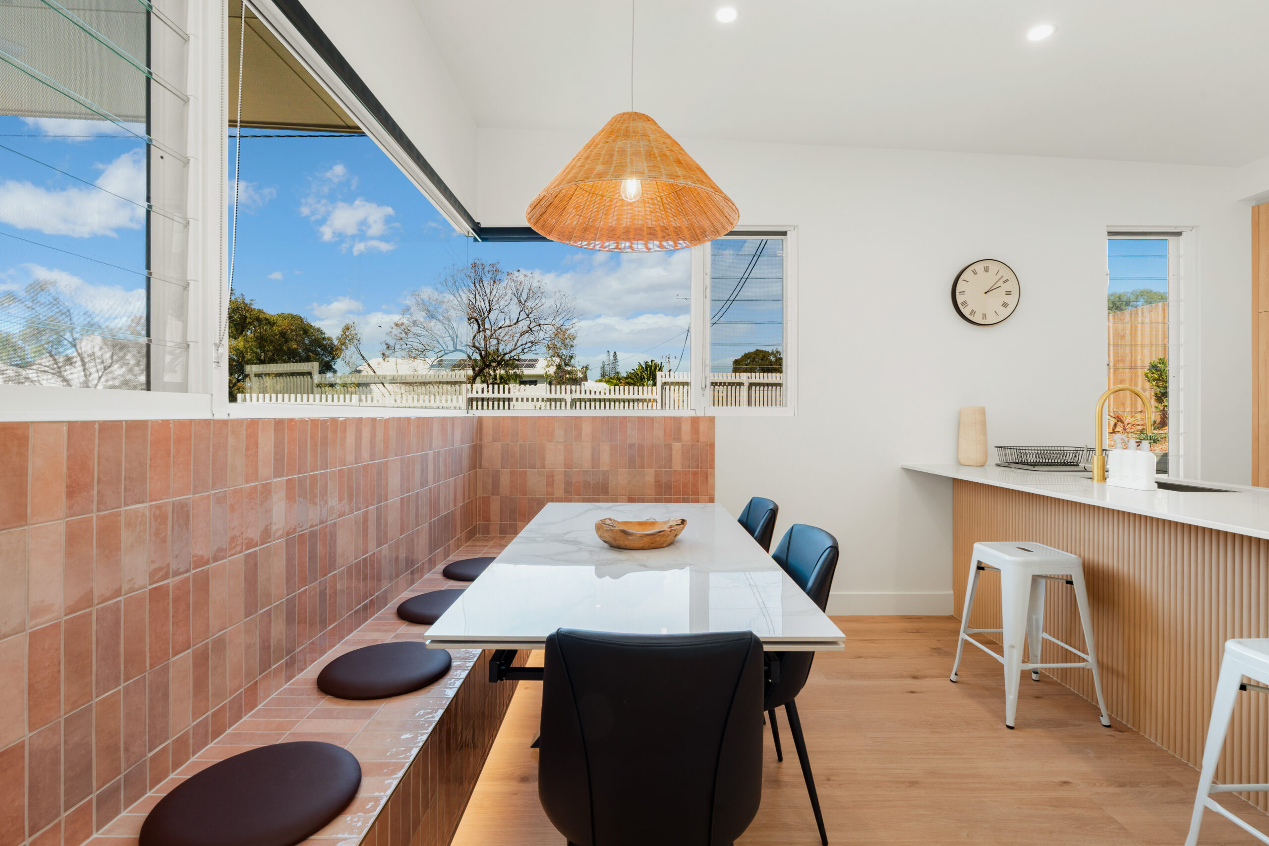 Spacious dining area with built-in seating at Poinciana Holiday House
