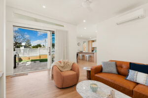 Open-plan living room opening onto the private yard at Poinciana Holiday House